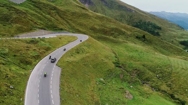 Alpine journey as cars and motorbikes drive along Grossglockner mountain road