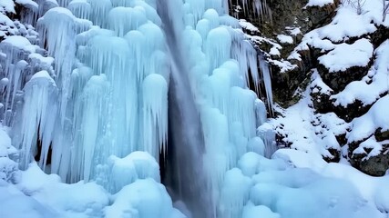 Frozen waterfall cascading through icicles - Powered by Adobe
