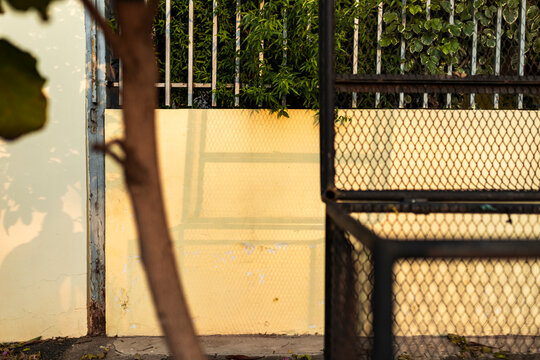 Shadows and geometric patterns on yellow wall in Asuncion, Paraguay