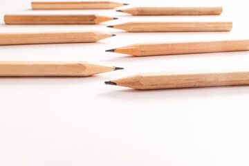 Wooden graphite pencils, sharpened tips, minimalist stationery concept, drawing and writing tools, arranged in symmetry, creative supplies for sketching, office, school, or art design context.