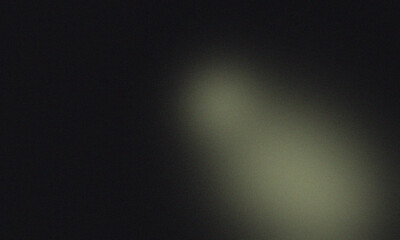 A blurry image featuring a gradient of dark black to light yellow with a soft light source effect