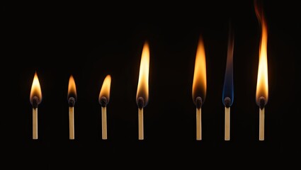 burning candle on black background