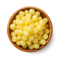 Corn balls in a wooden plate on a white background. Top view