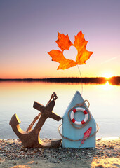 Driftwood Beach House with Anchor, Autumn Leaf, and Maritime Decor at Sunset