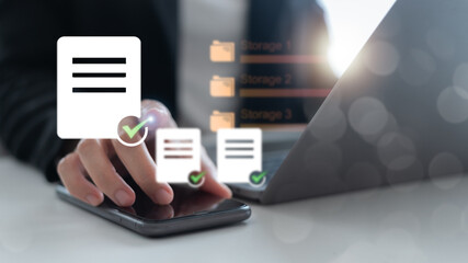 Businessman using smartphone and laptop with digital document management and cloud storage system concept for data organization, workflow, and online file access.