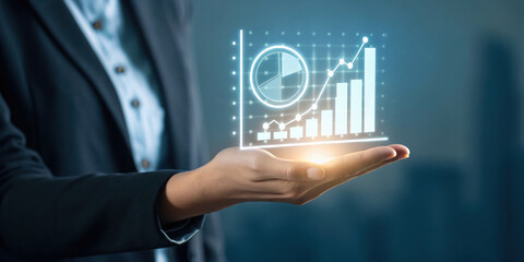 Business hand holding glowing holographic kpi chart with pie and bar graph showing growth