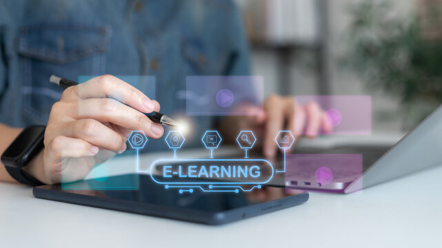 Business person using tablet and laptop with e-learning and online education platform icon for digital learning, remote training, and modern technology concept.