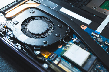 Close-up image of an all-in-one computer interior showing the motherboard, heat pipe cooling...