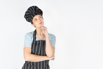 Female chef looking up thoughtfully and planning a recipe