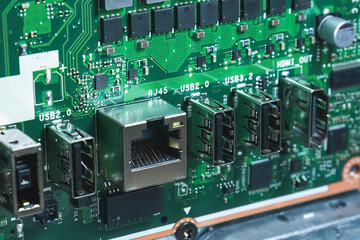Close-up image of an all-in-one computer interior showing the motherboard, heat pipe cooling system, RAM slot, processor, and electronic components. Inside View of All-in-One Computer Motherboard