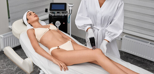 Microneedling radiofrequency lifting for legs skin of woman in cosmetology center to improve skin and fight wrinkles