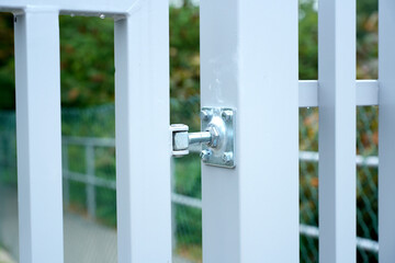 Metal gate hinge with bolts close-up