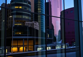 Modern glass facade reflecting cityscape, showcasing sleek windows, steel, property