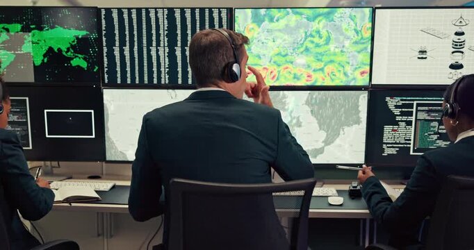 People, computer and screen of maps in control room, monitor weather and climate change. Back, meteorologist and headset with alert for satellite update, study storm pattern and disaster surveillance