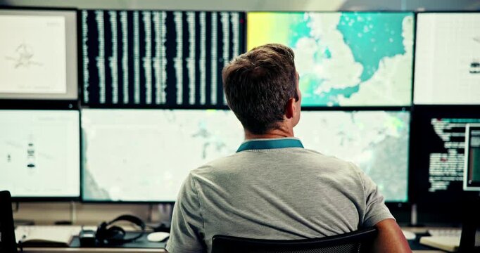 Man, computer and screen with satellite in control room, monitor weather and climate change. Back, meteorologist and online alert of hurricane update, study storm pattern and surveillance of disaster