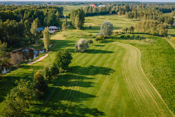 Aerial view of Avoti Golf Course featuring a scenic fairway, sand bunker, pond, trees, and...