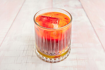 Image of a glass of cold orange juice with ice, ideal for summer