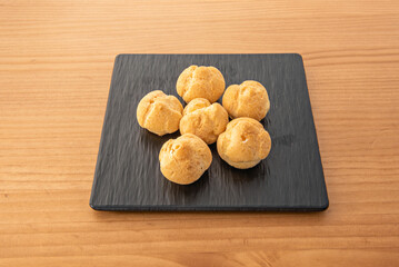 Orange fritters with citrus zest, covered in orange glaze, and garnished with candied citrus slices