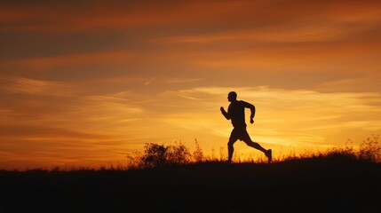 Silhouette of male runner against vibrant sunset sky in nature