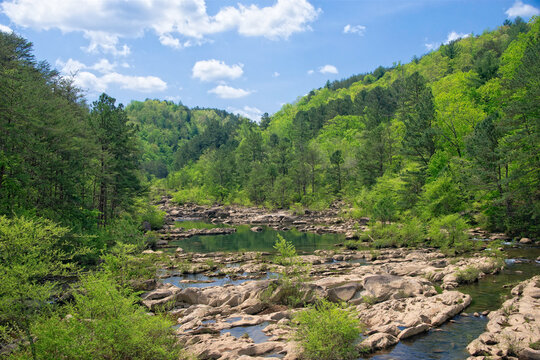 The peaceful Ocoee  river view surrounded by lush green hills in a sunny afternoon landscape