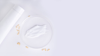 Tube of cream, petri dish, oatmeal on light background, skincare concept with copy space, real photo 16:9.