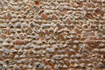 A Wall Built from Natural Flint Stones and Partial Bricks.