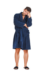 Full length portrait of sleepy young man wearing bathrobe, falls asleep while standing and waiting, leaning on his hand with eyes closed, feels tired isolated on transparent background