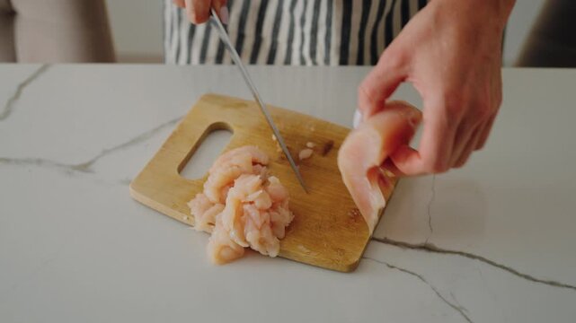 Cooking healthy food at home, woman chopping chicken meat for cutlet or soup. Dietary nutrition for stay healthy and slender, protein diet for sportsmen and people want to lose weight, home cook