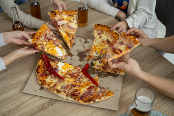 Friends enjoy sharing a delicious pizza at a cozy gathering in the afternoon