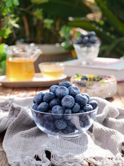 Fresh Blueberries in Glass Bowl with Tea - Healthy Breakfast Outdoor Setting
