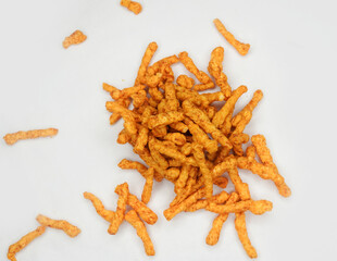 Heap of Crunchy spicy snacks isolated on white background. red chilli powder snack isolated on white background. Indian tea snacks concepts.