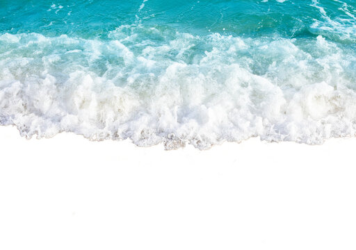 Waves crashing on sandy beach with foamy water creating dynamic and refreshing scene