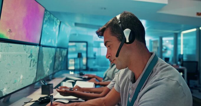 Man, computer and screen with headset in control room to monitor weather, climate change and report. Person, notes and online with satellite update, study storm pattern and surveillance for disaster