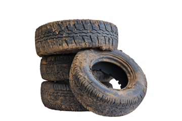 Stack of used tires with mud on transparent background highlighting texture and condition