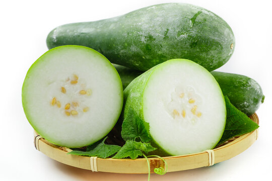 Fresh Winter Melon Sliced and Whole in Bamboo Basket on White Background