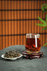 Freshly Brewed Chinese Tea with Organic Tea Leaves on Traditional Bamboo Mat