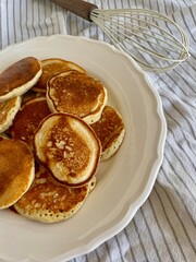 Close-up of hot homemade pancakes on a plate. Simple and appetizing, perfect for breakfast lovers.
