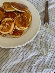 Freshly cooked homemade pancakes on a plate. Golden, fluffy, and ready to serve for breakfast or brunch.