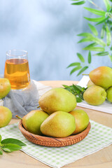 Fresh Ripe Pears in Wicker Basket with Pear Juice on Wooden Table - Natural Organic Fruit Display