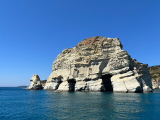 rock in the sea by a greek island
