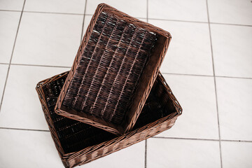 Wicker rectangular baskets on tiled floor.