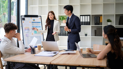 Business professionals presenting charts and data during a strategic team meeting.