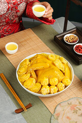 Golden Fish Maw Soup with Chicken Meatballs - Traditional Chinese Cuisine Served with Tea and Chopsticks