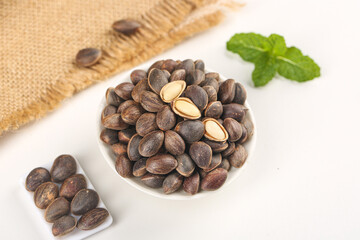 Fresh Yunnan Pine Nuts Mountain Harvest with Mint Leaves in White Bowl China