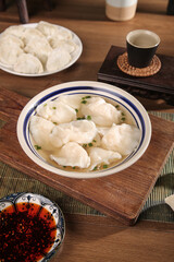 Large Handmade Mackerel Seafood Dumplings with Filling in Clear Broth on Wooden Table