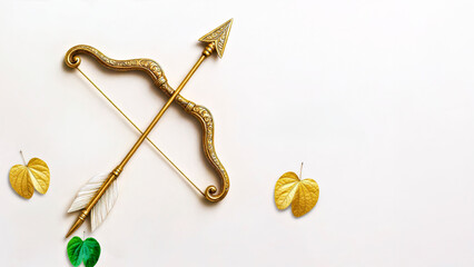Flat Lay of Golden Bow and Arrow and Apta Leaves with Copy Space 