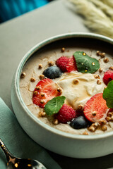 Porridge with berries and yogurt or cream