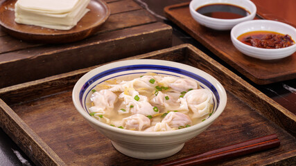 Handmade Wontons in Clear Broth Soup with Traditional Asian Table Setting