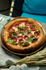 pepperoni pizza with arugula on table