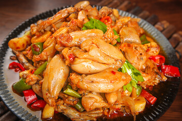 Sautéed Frog Legs with Peppers in Cast Iron Pot - Spicy Asian Cuisine Dish